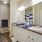 Large well lit bathroom with white accents 