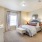 Large well lit bedroom with plush carpets and large windows 