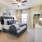 Large well lit bedroom with plush carpets and large windows 